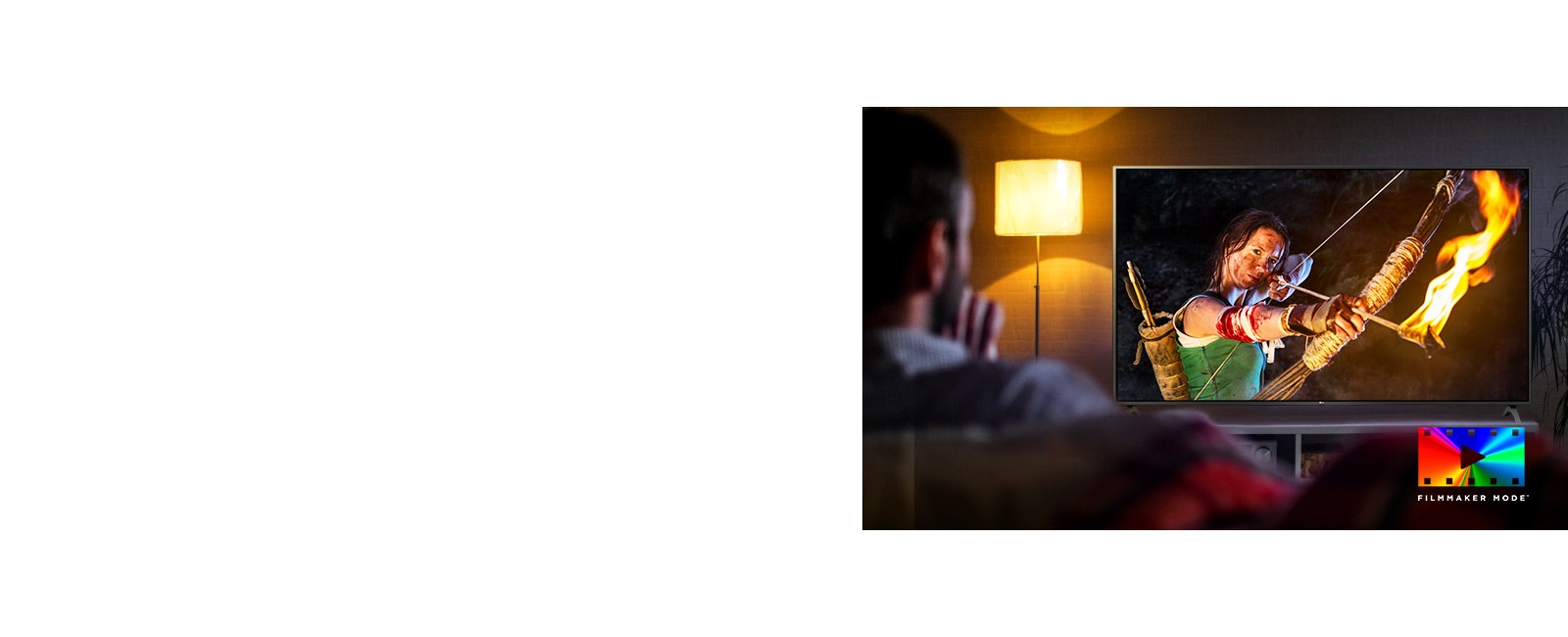 A man is sitting on a couch watching an action movie. The girl on the TV has a fully drawn bow and arrow.