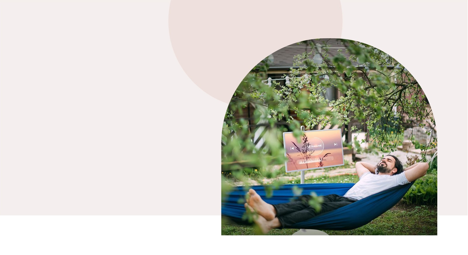 TV is placed in front of hammock in terrace. The image is cropped in arch-shape.