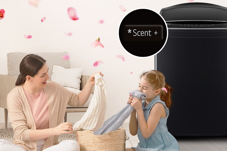 A woman and a baby are smelling the scent from the laundry.