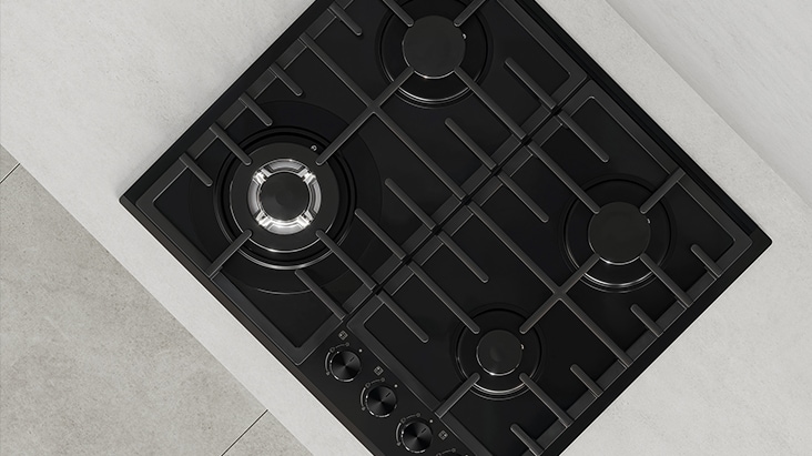 Top view of black gas cooktop with durable cast-iron grates designed for stable and secure cookware support.