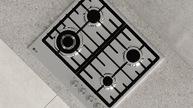 Top view of black gas cooktop with durable cast-iron grates designed for stable and secure cookware support.
