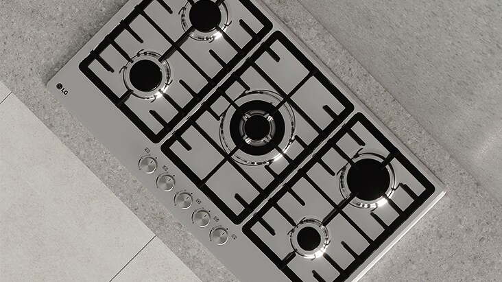 Top view of black gas cooktop with durable cast-iron grates designed for stable and secure cookware support.