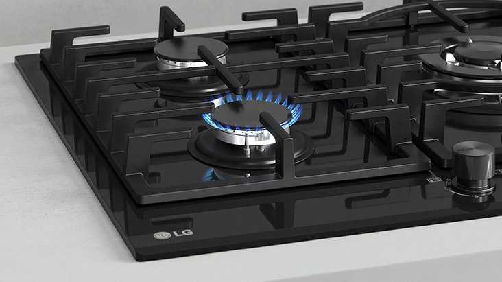 Black gas cooktop with blue flame and flame-failure safety that automatically shuts off gas.
