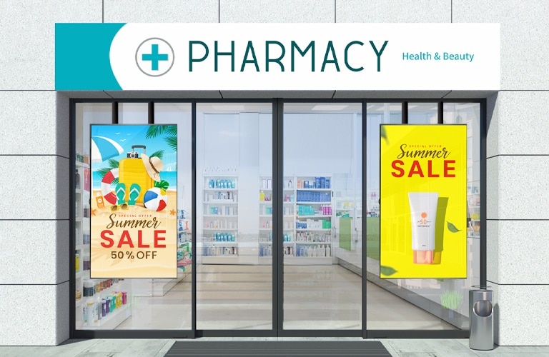 Inside the pharmacy, there are two large displays installed —one on the left side of the store window and the other on the right—showcasing clear advertising content.