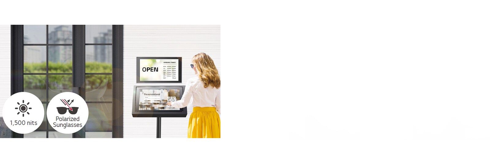 A 22XE1J is installed on the wall at the entrance of the building with another 22XE1J stand below for reservation purposes. The lady with sunglasses is using the 22XE1J screen with a touch overlay to make a reservation. The screen remains visible even when under direct sunlight.