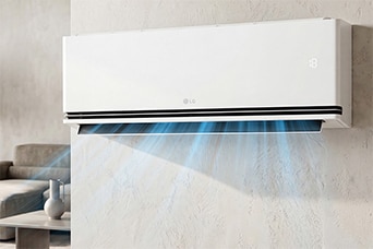 A woman holding a remote control pointed at a wall-mounted air conditioner in a bright room.