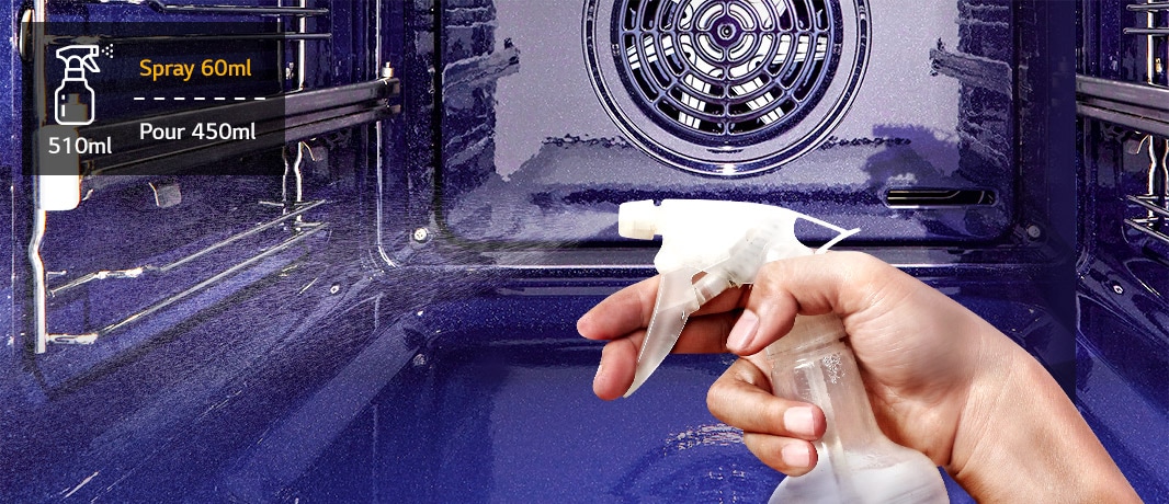 An image of spraying water on the oven wall with a sprayer.