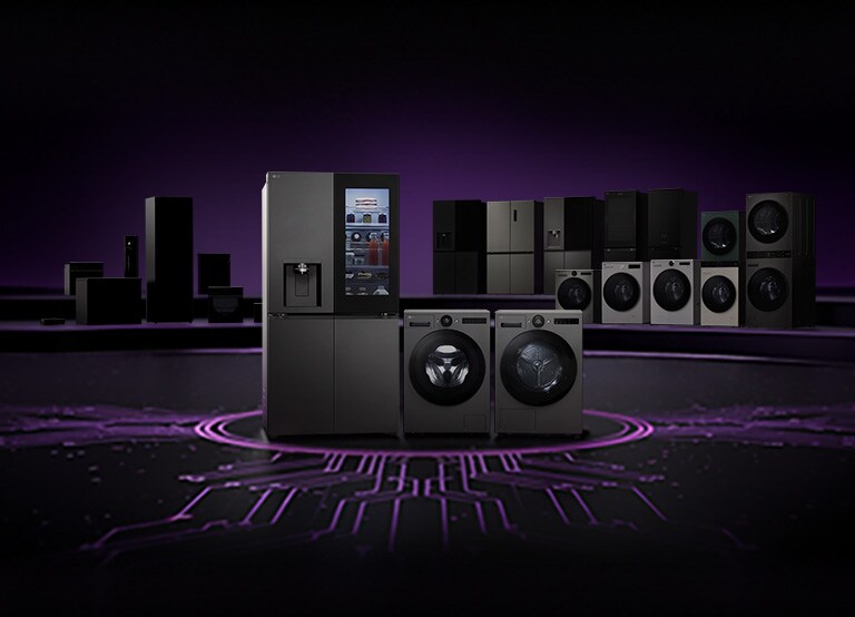 Lineup of LG home appliances including refrigerators, washing machines, dryers, and kitchen appliances displayed on a dark stage with a circuit board pattern floor	