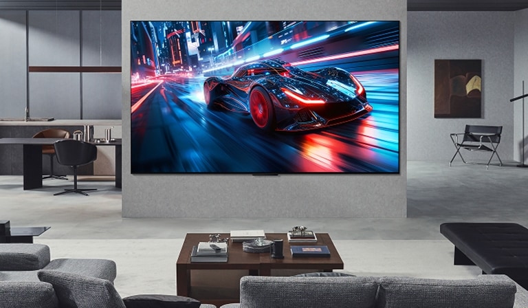 Living room with a huge LG Ultra Big TV mounted on the wall. On the screen is a car racing game. Because of the screen size, the content feels so much more immersive.
