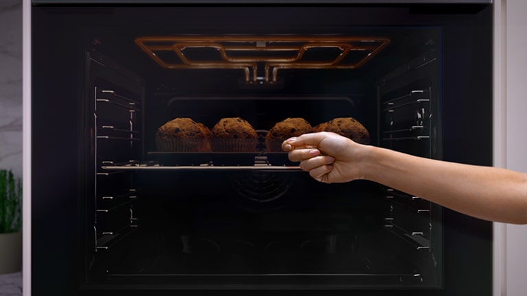 Image of hand knocking on oven door.