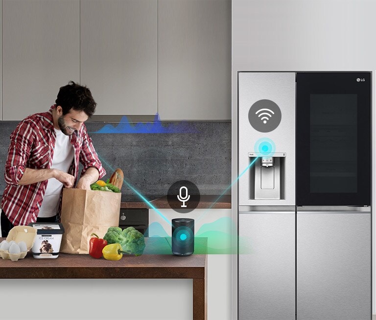 A man stands in a kitchen unloading produce from a grocery bag and speaks.