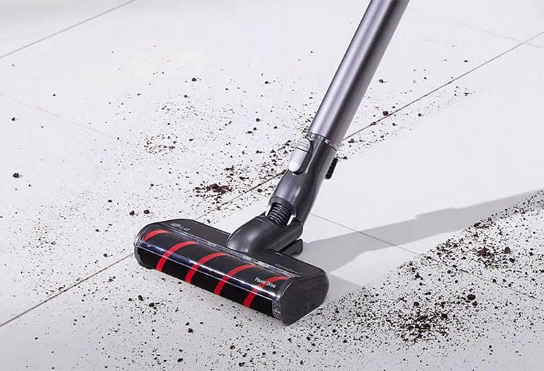 Three images in line: the first shows the vacuum vacuuming dirt from a hard surface.
