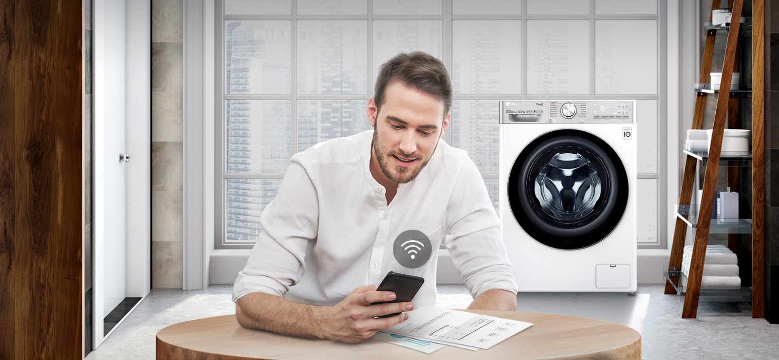 A man is monitoring the condition of the washing machine through a mobile phone app.