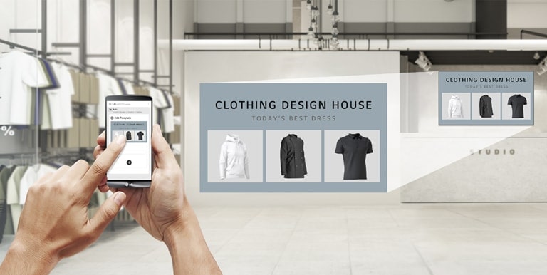 In a clothing store, a user is using the app to produce promotional content to display on the UM5K installed on the store’s wall.