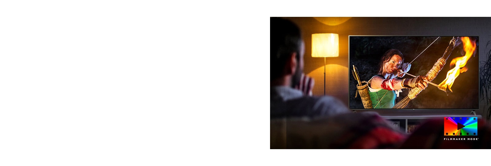 A man is sitting on a couch watching an action movie. The girl on the TV has a fully drawn bow and arrow.