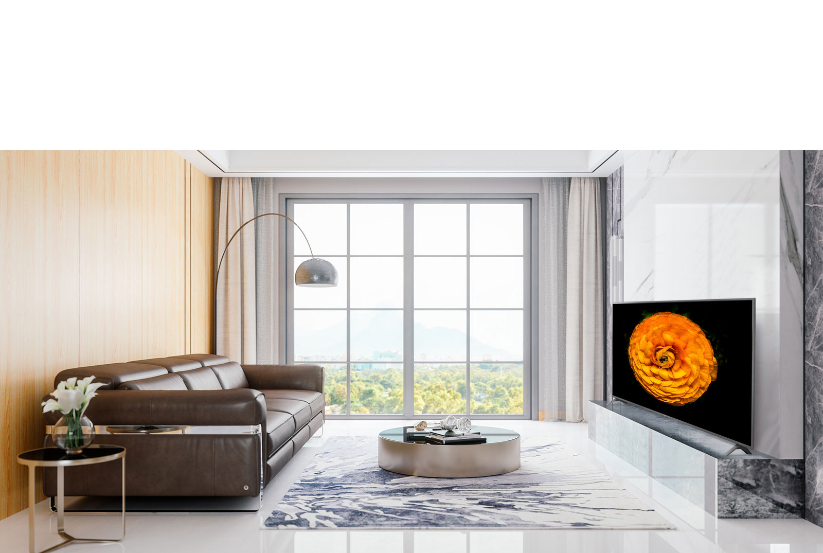 LG UHD TV, located on the wall in a living room with the minimal interior. Image of a flower is shown on the TV screen.