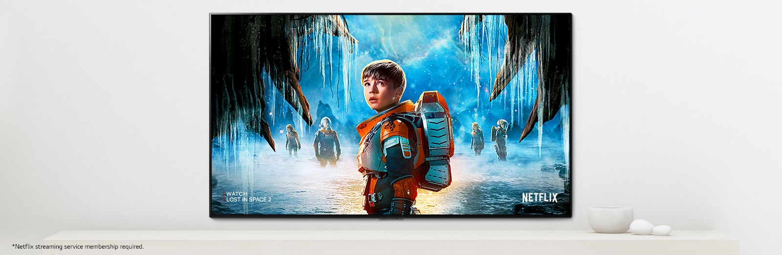 A scene of Lost in Space 2 series showing main characters with an intense look on a TV screen A scene of Lost in Space 2 series showing main characters with an intense look on a TV screen Movie