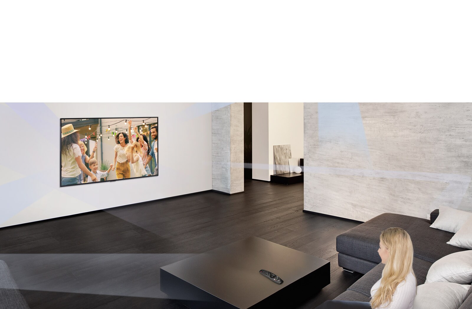 Woman in large and minimalistic living room watching people dancing on TV
