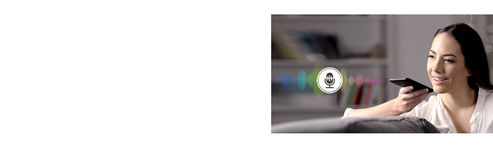 A woman is controlling TV by speaking to a remote control which has voice recognition.