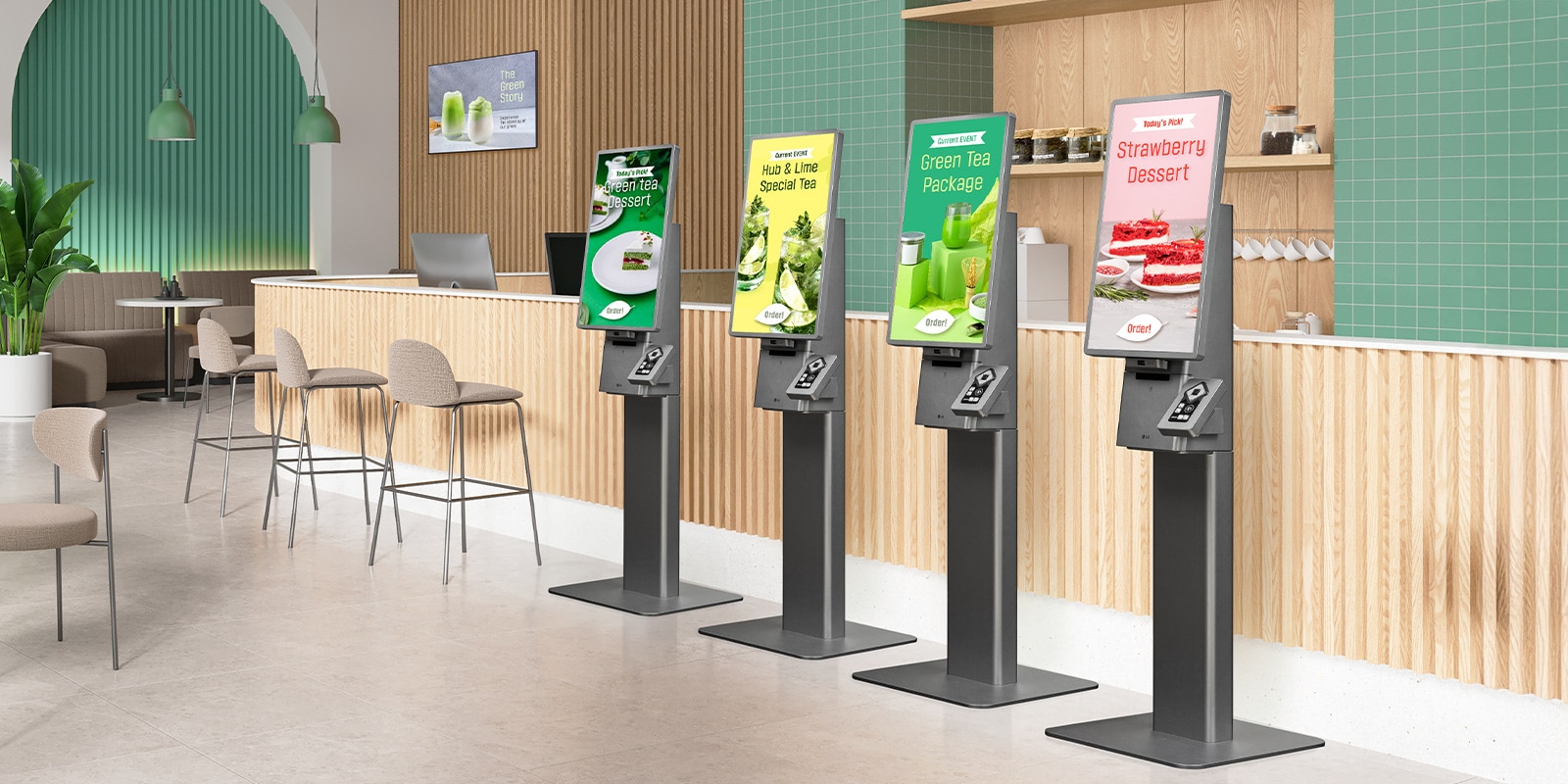 There are four LG Kiosks placed side by side in a cafe, each displaying different menu advertisements on their standby screens.