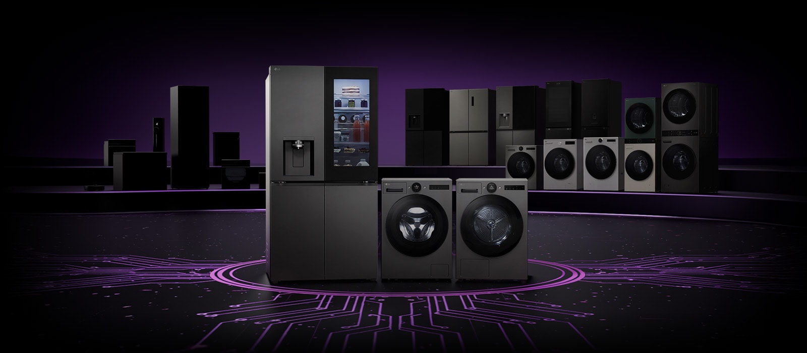 Lineup of LG home appliances including refrigerators, washing machines, dryers, and kitchen appliances displayed on a dark stage with a circuit board pattern floor	