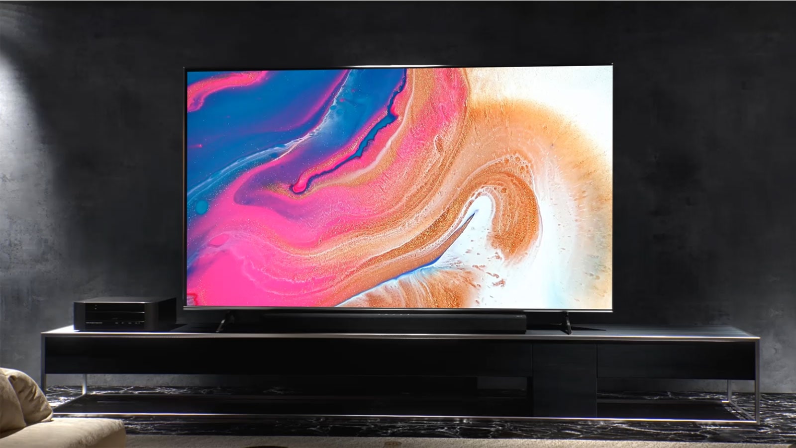 Installation video showing a slim TV in a dark room being mounted against the wall.