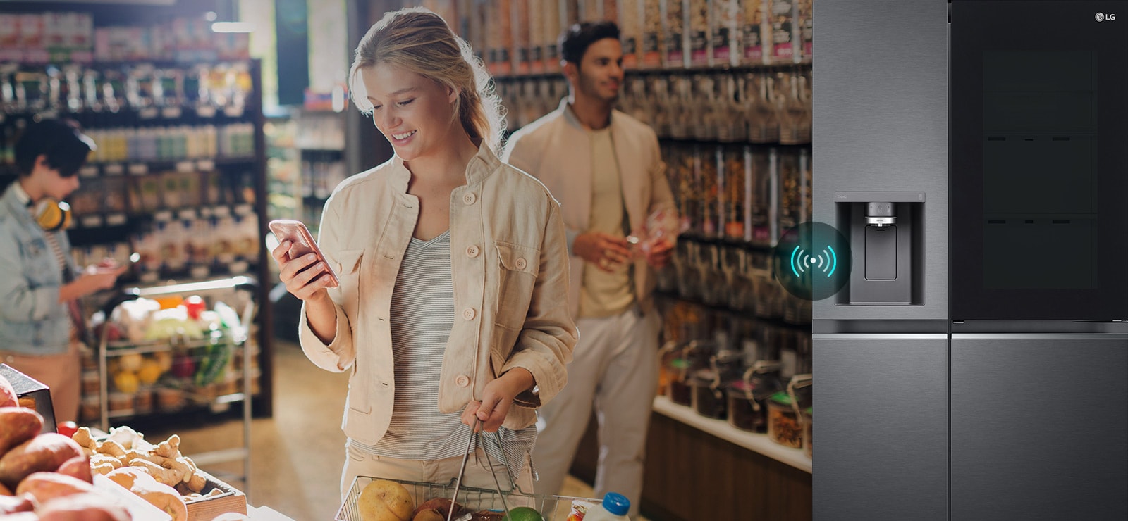 Image on the left shows a woman standing in a grocery store looking at her phone. Image on the right shows the refrigerator front view. In the center of the images is an icon to show connectivity between the phone and refrigerator.