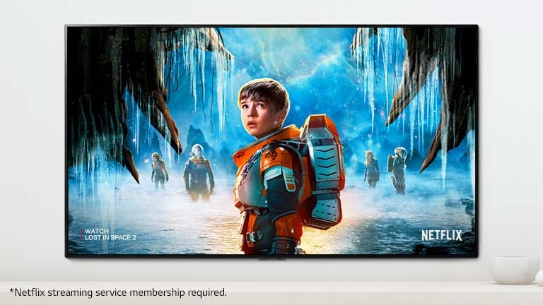 A scene of Lost in Space 2 series showing main characters with an intense look on a TV screen