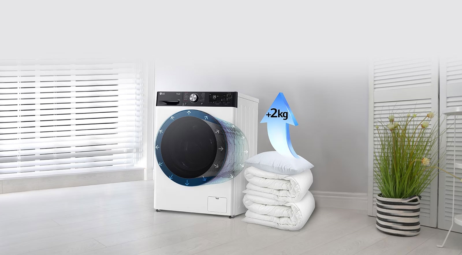 Antklodės ir pagalvės šalia skalbyklės, o ant pagalvės yra rodyklė, nurodanti 2 kg padidėjimą.