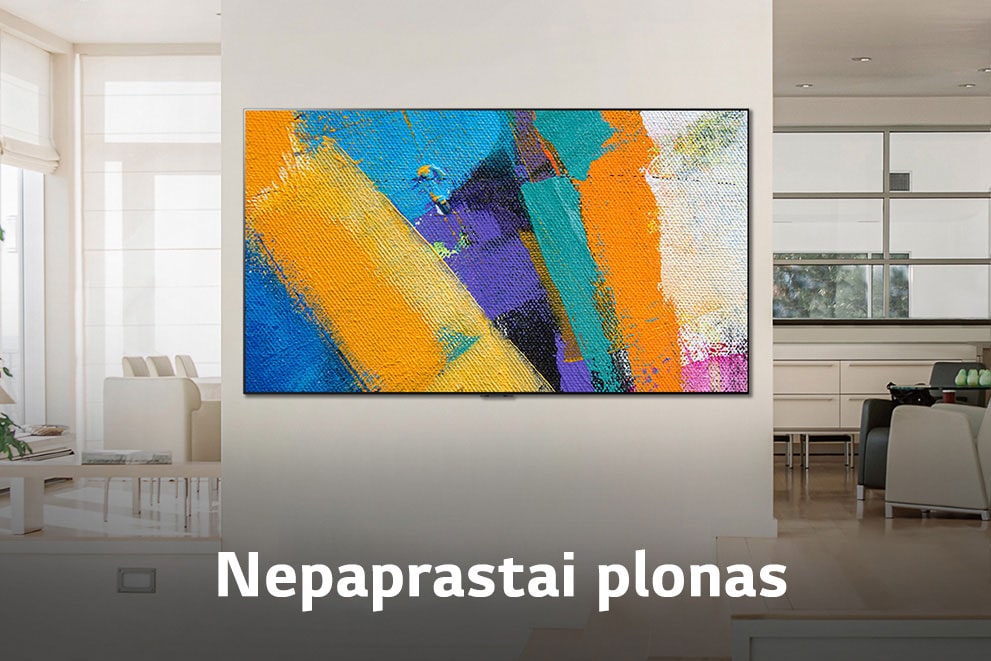 Ant sienos įrengto „Gallery“ tipo TV, kuriame rodomas meno kūrinys, platus vaizdas iš priekio Sužinokite, kodėl dėl SAVARANKIŠKAI UŽSIDEGANČIŲ PIKSELIŲ gyvenimas tampa meniškesnis