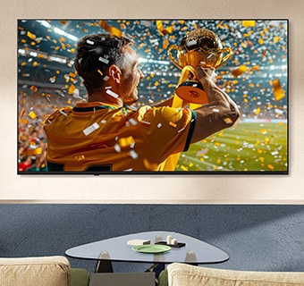 LG NANO 4K UHD AI NU85 Ultra Big TV rodo sporto pergalės sceną su konfeti ir iškelta taure, pabrėžiant ryškias spalvas, aiškias detales ir įtraukiantį mastelį.