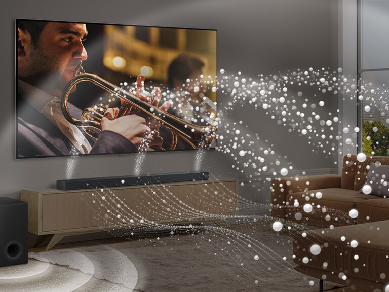 LG „Soundbar“, LG TV ir žemųjų dažnių garsiakalbis moderniame miesto bute. LG „Soundbar“ skleidžia garso bangas iš baltų lašelių, kurios užpildo kambarį, o žemųjų dažnių garsiakalbis sukuria garso efektą iš apačios. Bendrai sistema sukuria garso kupolo efektą.
