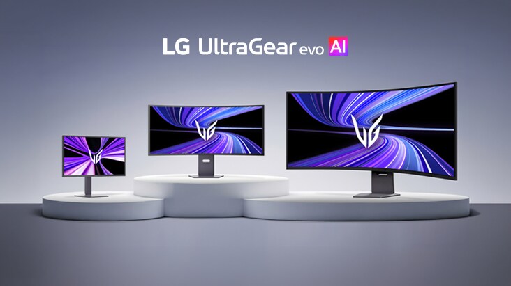 Trys skirtingų dydžių LG UltraGear evo AI monitoriai eksponuojami greta ant baltų pakylų, šviesiai pilkame fone, su logotipu viršuje.
