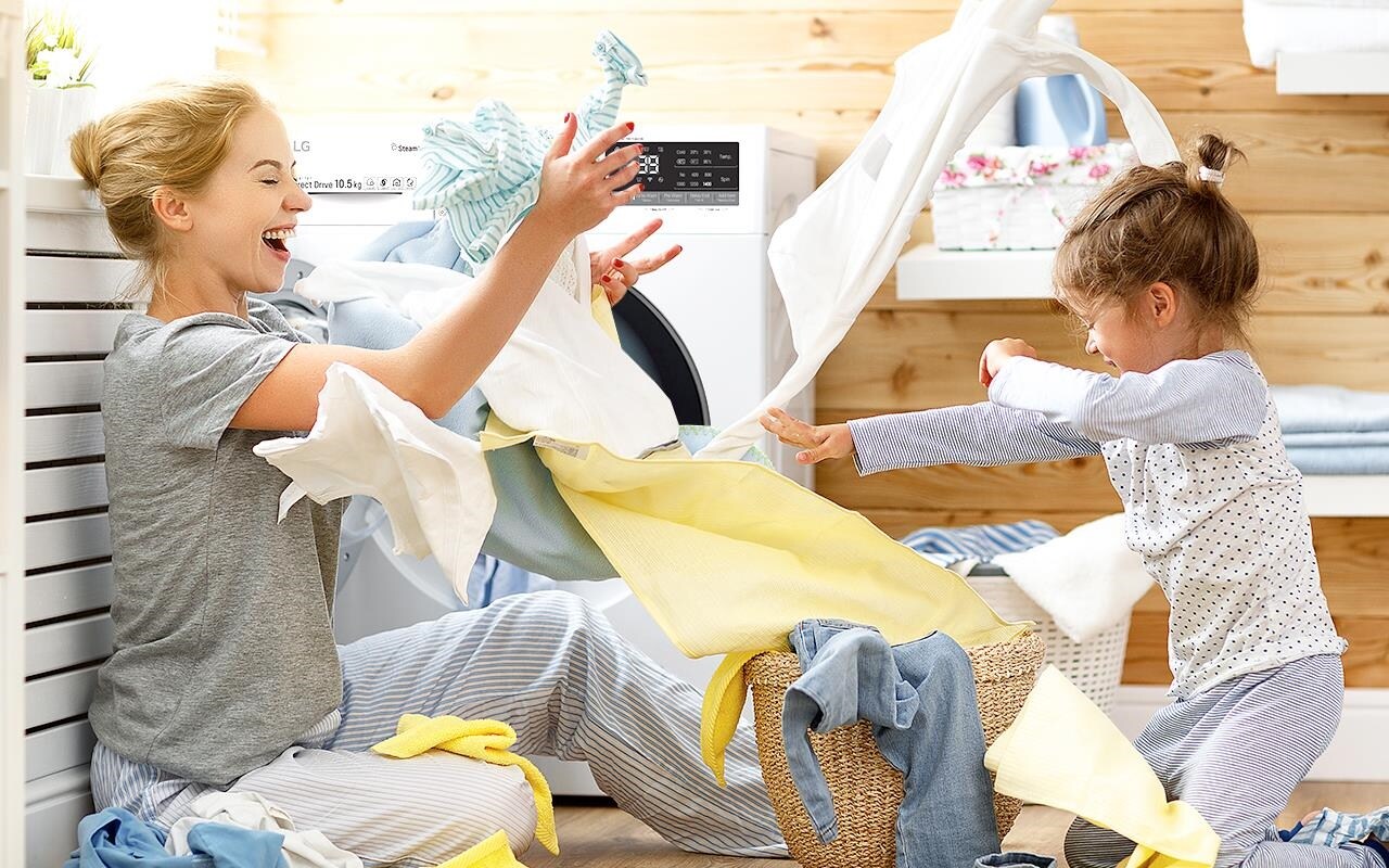 A woman plays with her child in the laundry room - sending clothes flying everywhere. Who says washing has to be boring? | More at LG MAGAZINE