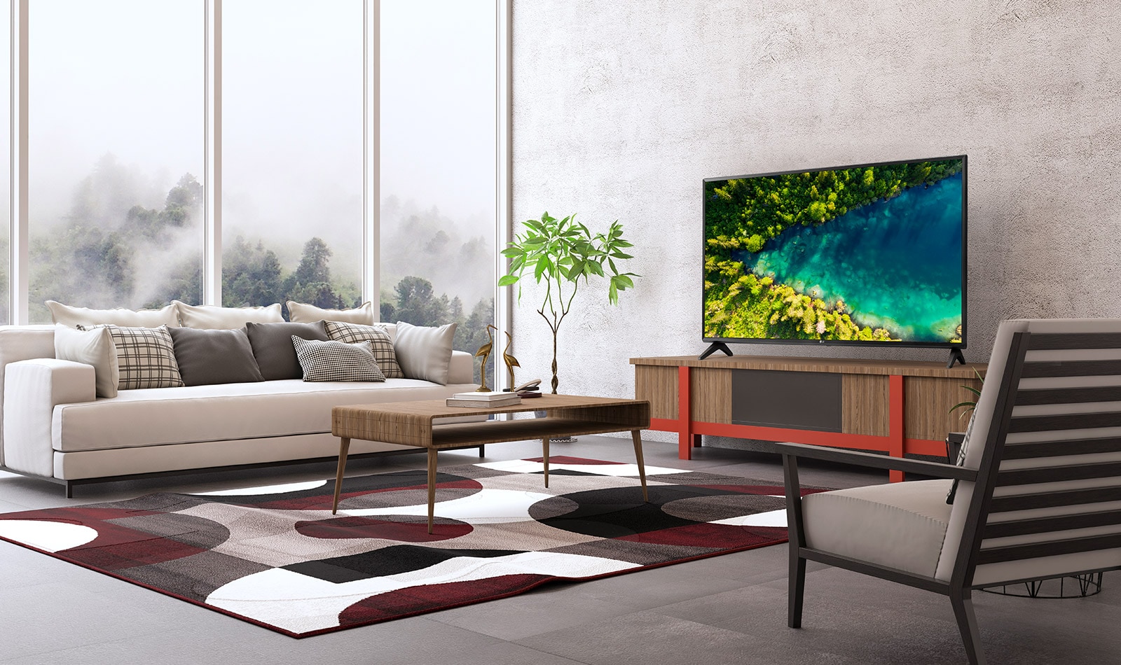 Modernā, vienkāršā mājas interjerā redzams televizors, kurā paveras skats no augšas uz upi, kas plūst caur biezu mežu.