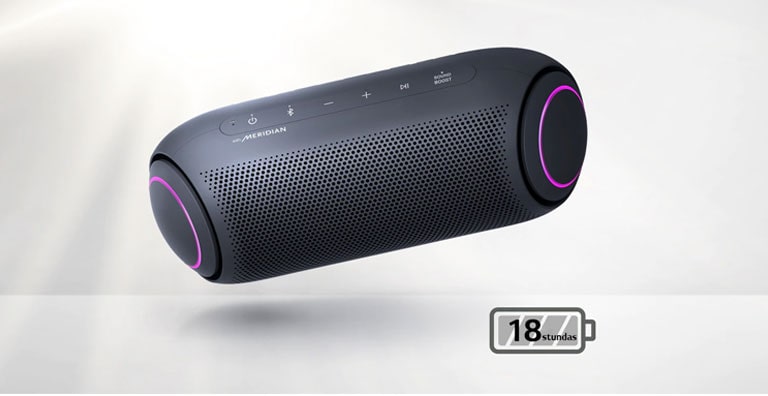 LG XBOOM Go pagriezts uz leju lidinās gaisā. Zemo frekvenču pastiprinātāja gaismiņas ir fuksīna krāsā.