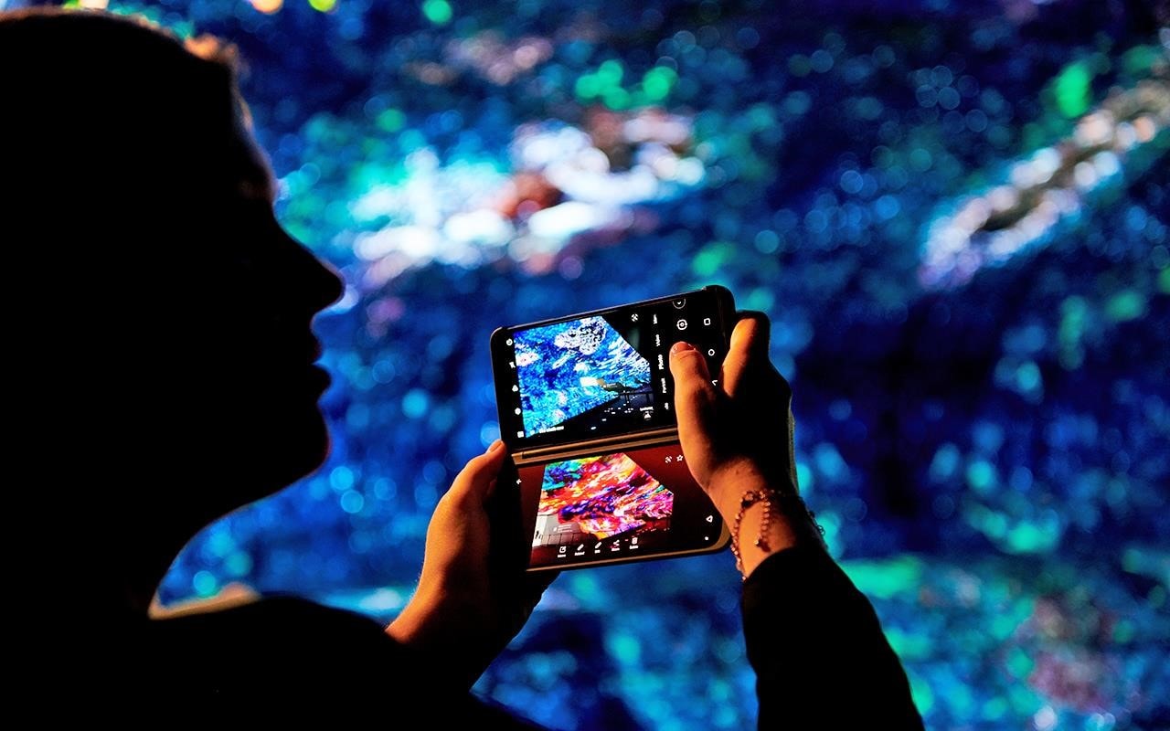 An IFA visitor takes a shot of the OLED Falls at LG's IFA 2019 exhibition | More at LG MAGAZINE