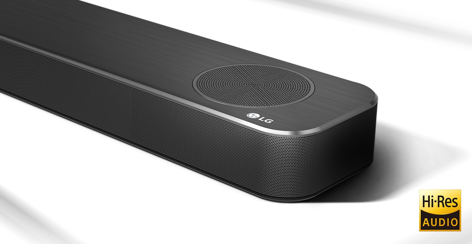 Close-up right side of LG Soundbar with LG logo shown on the bottom right corner. Hi-Res logo is shown below the product. 