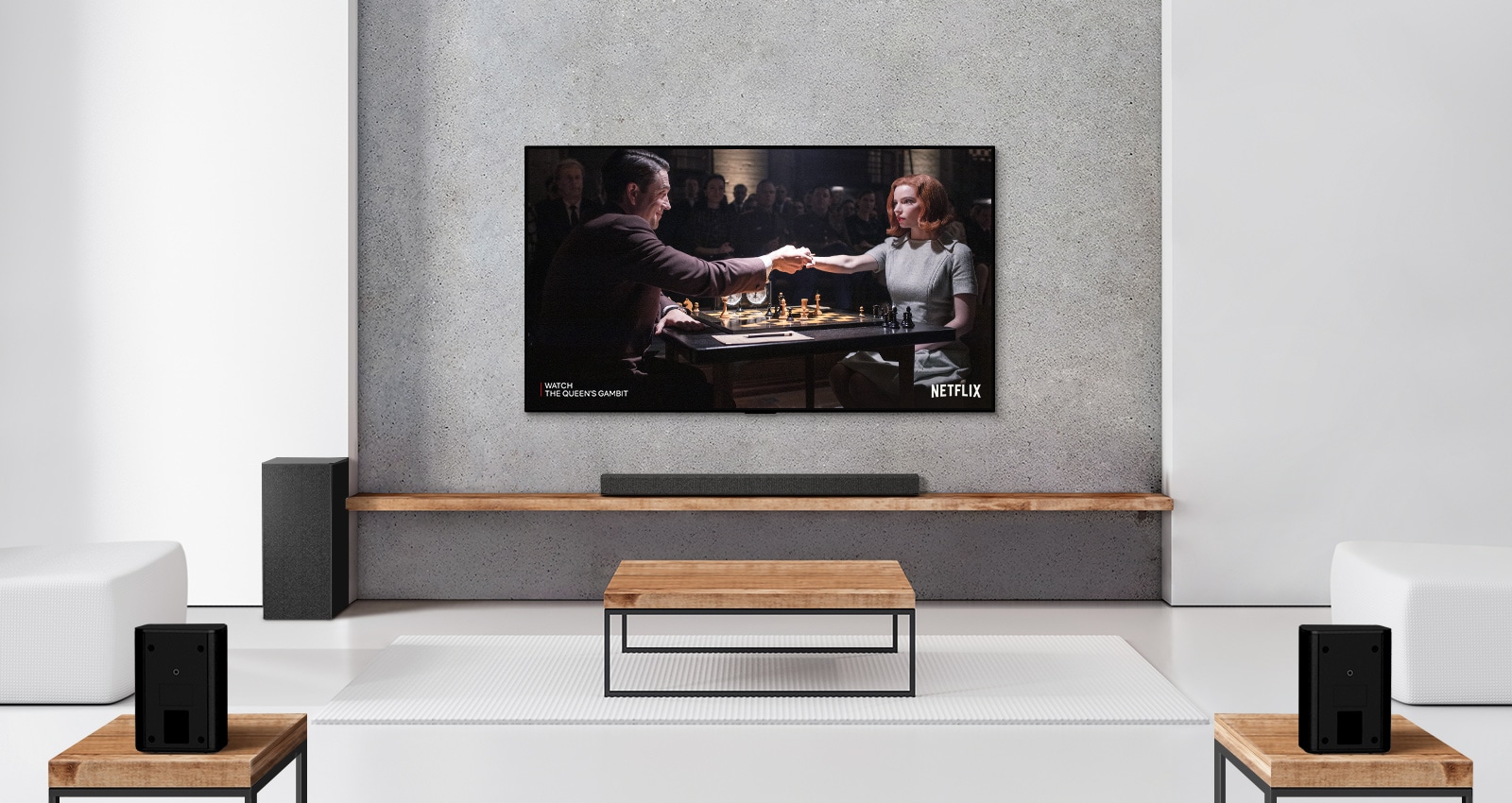 A set of 2 rear speakers, subwoofer, and a soundbar, and TV are in a white living room. A poster of a TV show is on TV screen. 