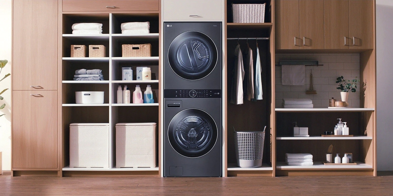 A black LG Wash Tower is installed with shelving and a closet in a wall unit.