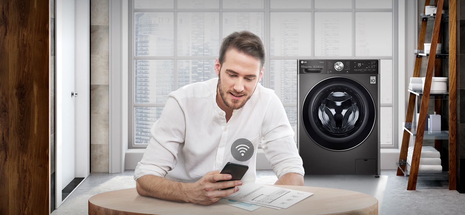 A man is monitoring the condition of the washing machine through a mobile phone app.