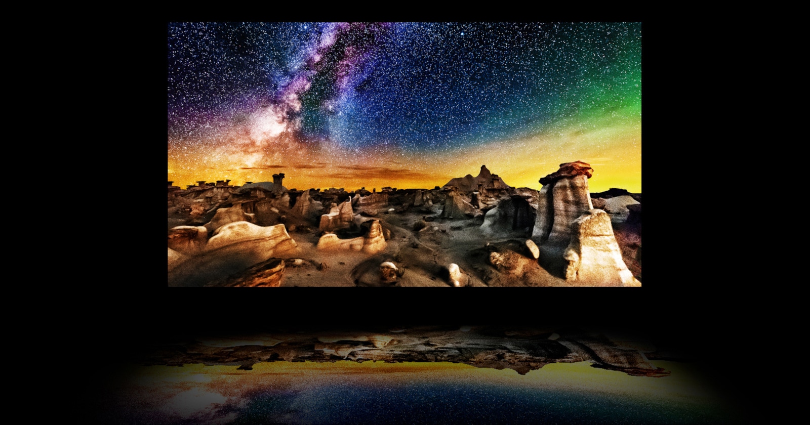 A video of a TV's layers with a starry nighttime landscape photograph on the main OLED display. The backlight disappears, and the polarizer, colour filter, and OLED come together to produce an image so bright that it reflects below the TV like on water.