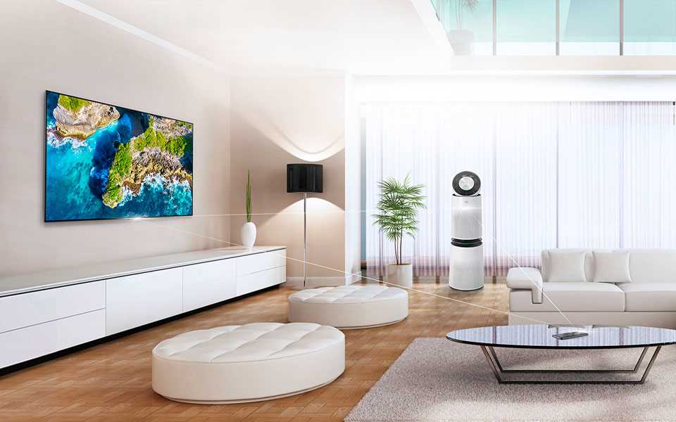 An LG PuriCare™ Air Purifier and OLED TV on display in a living room with seating.