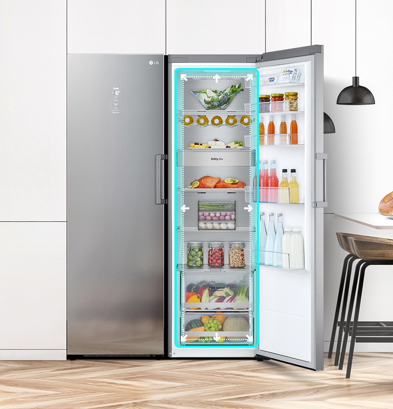 Visning foran av kjøleskapet på kjøkkenet, med åpen dør som viser frem varene på innsiden. Et blått kvadrat fremhever innsiden med piler som peker utover for å indikere at det er romslig på innsiden.