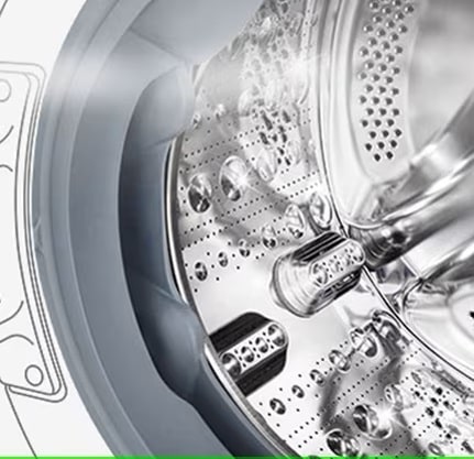 Bildet av innsiden av vaskemaskinen hvor de rustfrie trommelribbene kan sees.