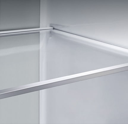 A diagonal view of the shelf with metallic paneling on the interior of the refrigerator.