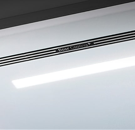 A diagonal view up into the top of the refrigerator showing the soft LED lighting.