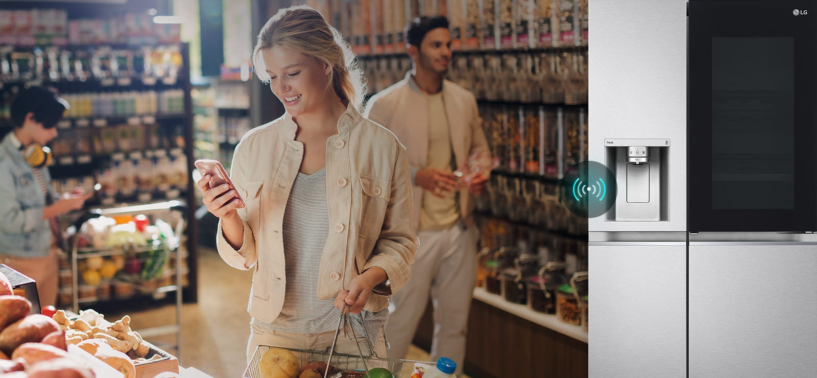 Image on the left shows a woman standing in a grocery store looking at her phone. Image on the right shows the refrigerator front view. In the center of the images is an icon to show connectivity between the phone and refrigerator.
