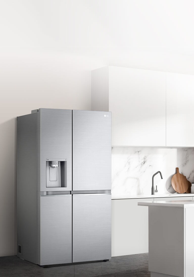 A side view of a kitchen with a  refrigerator installed.