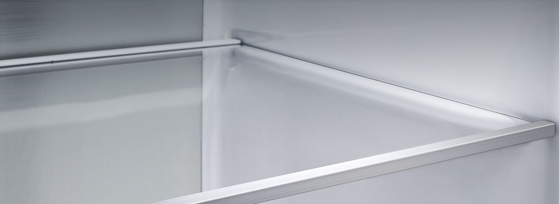 A diagonal view of the shelf with metallic paneling on the interior of the refrigerator.